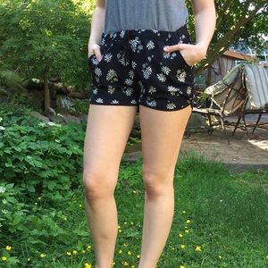 Daisy patterned black shorts